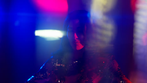 Close-Up-Of-Woman-In-Nightclub-Bar-Or-Disco-Dancing-With-Sparkling-Lights